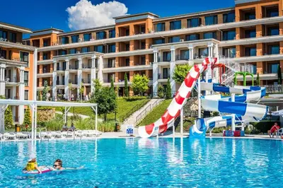 a hotel swimming pool with a water slide at Seaside Serenity Studio - Premier Fort Beach in Sveti Vlas