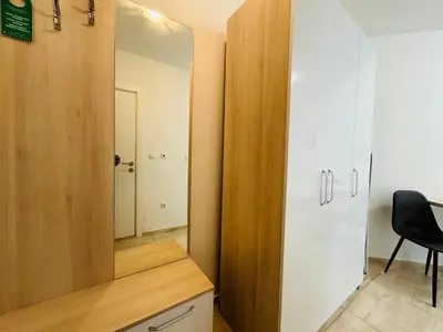 a room with a mirror and a desk with a chair at HORIZON 19 'Б' Studio Sveti Vlas in Sveti Vlas