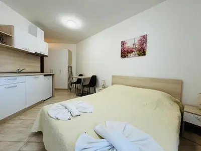 a bedroom with a bed with two towels on it at HORIZON 19 'Б' Studio Sveti Vlas in Sveti Vlas