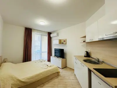 a small room with a bed and a sink in it at HORIZON 19 'Б' Studio Sveti Vlas in Sveti Vlas
