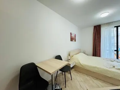 a bedroom with a bed and a table and chairs at HORIZON 19 'Б' Studio Sveti Vlas in Sveti Vlas