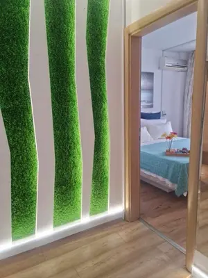 a mirror in a room with a green wall at Aglaya 2 - Pomorie Bay in Pomorie