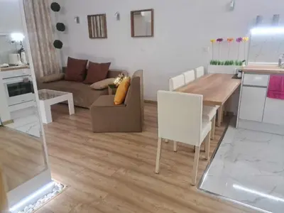 a living room with a couch and a table at Aglaya 2 - Pomorie Bay in Pomorie