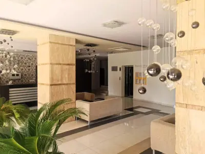 a living room with a couch and a chair at Aglaya 2 - Pomorie Bay in Pomorie