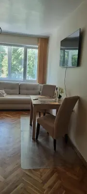 a living room with a table and a laptop on it at Central Luxe Apartament Mimoza in Varna City