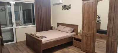 a small bedroom with a bed and a window at Central Luxe Apartament Mimoza in Varna City