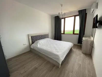 a bedroom with a white bed and a window at Vineyards Resort - Apartment Panorama in Kableshkovo