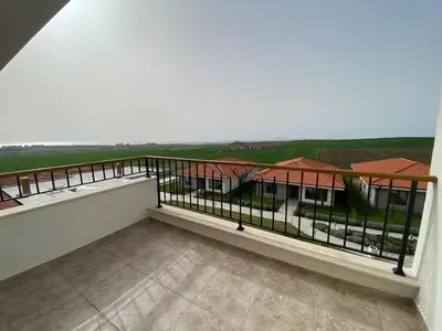 a balcony with a view of a house at Vineyards Resort - Apartment Panorama in Kableshkovo