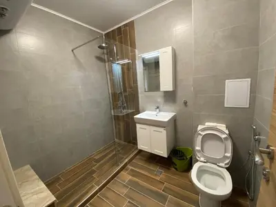 a bathroom with a toilet and a sink at Vineyards Resort - Apartment Panorama in Kableshkovo