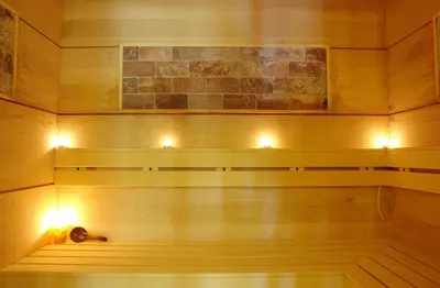 a sauna with two lights on the wall at Vineyards Resort - Apartment Panorama in Kableshkovo