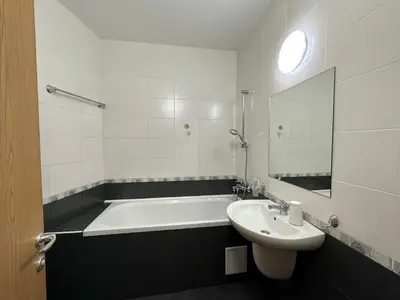 a white bathroom with a tub and a sink at Studio in Garden of Eden D402 - Sveti Vlas, Bułgaria in Sveti Vlas