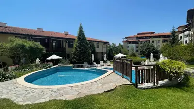 a swimming pool in the middle of a yard at Studio in Garden of Eden D402 - Sveti Vlas, Bułgaria in Sveti Vlas