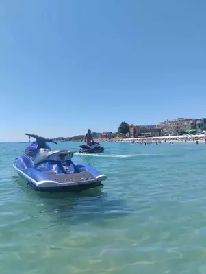 two people riding on a jet ski in the water at Oasis2 in Nesebar