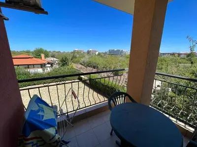 a balcony with a table and a view of a field at Oasis2 in Nesebar