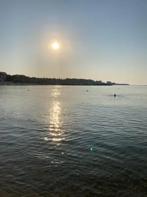 a large body of water with the sun in the sky at Oasis2 in Nesebar