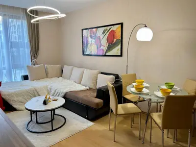 a living room with a couch and a table at Prestige Fort Sveti Vlas Aparthotel 1 bedroom 4 people in Sveti Vlas
