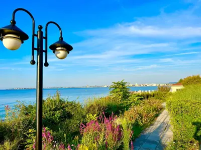 a street light next to a path next to the water at Prestige Fort Sveti Vlas Aparthotel 1 bedroom 4 people in Sveti Vlas