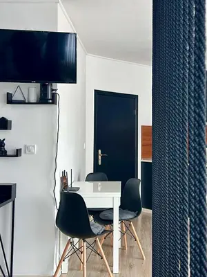 a dining room with a white table and chairs at Karolina Apartment 65 in Sunny Beach