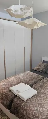 a bed with two white towels on top of it at Апартамент ЛазуР in Burgas City