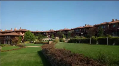 a row of apartment buildings with a green lawn at Sozopol Созопол MORE SUN 2 Б Sozopolis in Sozopol