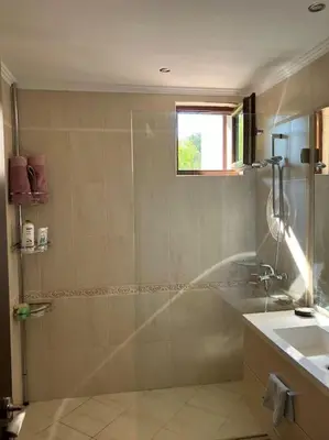 a bathroom with a shower and a sink at Двуспални апартаменти Оазис Бийч клуб in Lozenets