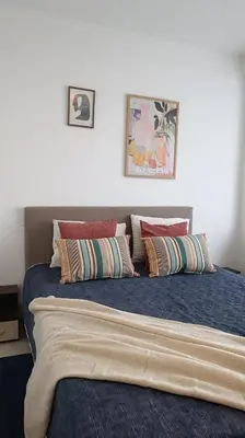 a bedroom with a bed with pillows on it at Sea view family apartment Saint Vlas in Sveti Vlas