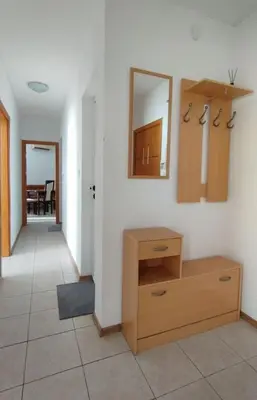 a room with a dresser and a mirror on a wall at Sea view family apartment Saint Vlas in Sveti Vlas