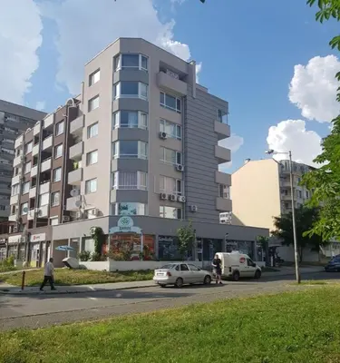 a tall building with cars parked in front of it at Дом Крумови in Burgas City