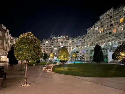 a large apartment building at night with a park at Seaside View Apartment in Varna in Varna City