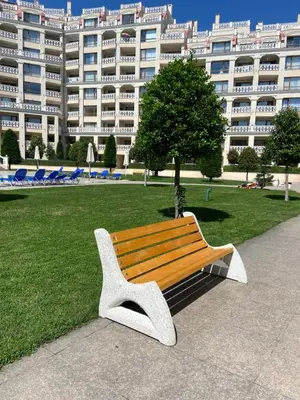 a park bench in front of a large building at Seaside View Apartment in Varna in Varna City