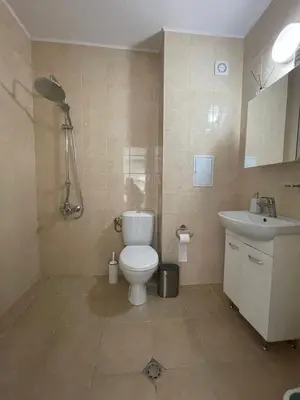 a bathroom with a toilet and a sink at Апартамент Лариди in Sozopol