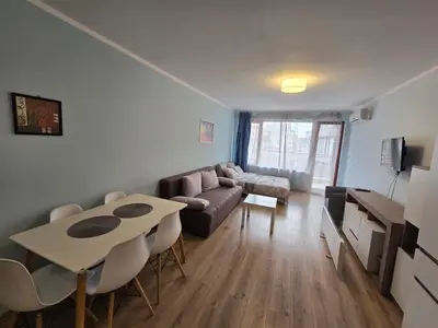 a living room with a couch and a table at Апартамент ЛаХабана до плажа в Поморие in Pomorie