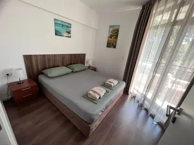a bedroom with a bed with two towels on it at Sea and Sand Apartment in Sozopol
