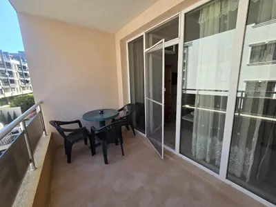 a balcony with a table and chairs in a apartment at Студиa Блу минута от плажа in Pomorie