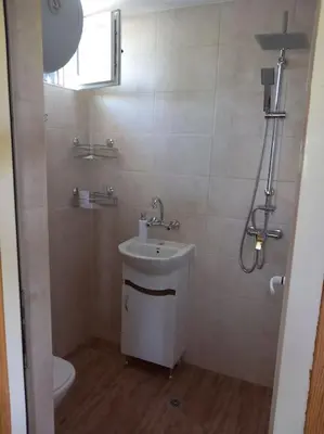 a bathroom with a sink and a toilet at Къща Виктория in Banya
