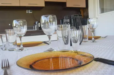 a table with wine glasses and a plate on it at Къща Виктория in Banya