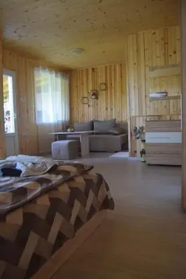a bedroom with a bed and a couch in a room at Къща Виктория in Banya