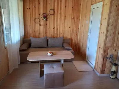 a living room with a couch and a coffee table at Къща Виктория in Banya