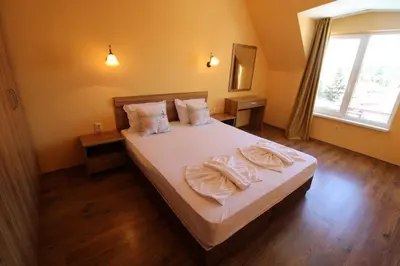 a bedroom with a bed with two towels on it at Horizont - Menada Apartments in Sunny Beach