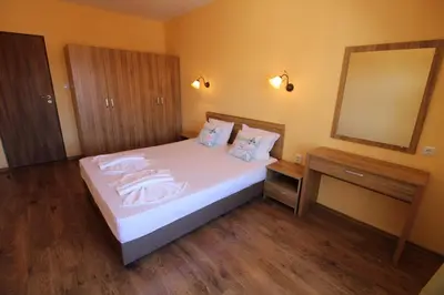 a bedroom with a bed with a large mirror at Horizont - Menada Apartments in Sunny Beach
