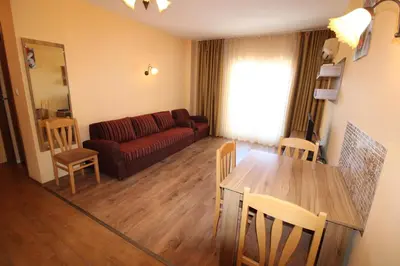 a living room with a couch and a table and chairs at Horizont - Menada Apartments in Sunny Beach
