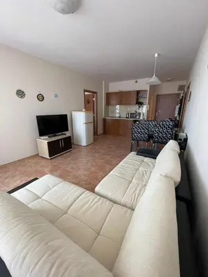 a living room with a couch and a kitchen at Midia SP Apartments in Aheloy