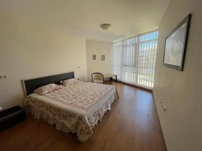 a bedroom with a bed and a large window at Midia SP Apartments in Aheloy