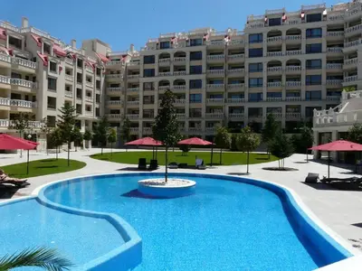 a large apartment building with a large swimming pool at Sunrise Luxury Sauth Bay in Varna City