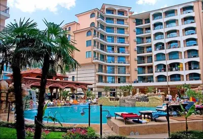 a resort with a swimming pool and a large building at Апартаменты с одной спальней Carolina in Sunny Beach