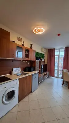 a kitchen with a washing machine in the middle at Апартаменты с одной спальней Carolina in Sunny Beach