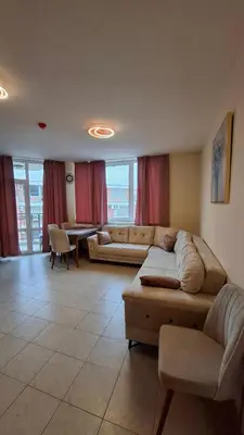 a living room with a couch and a table at Апартаменты с одной спальней Carolina in Sunny Beach