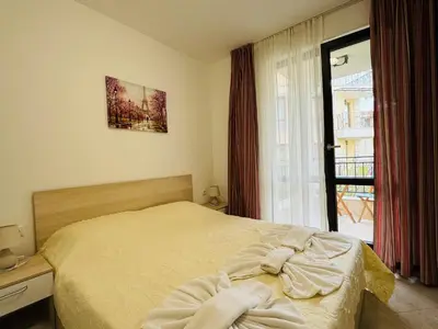 a bedroom with a bed and a large window at HORIZON 18 'Б' Apartment Sveti Vlas in Sveti Vlas