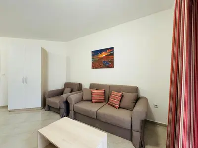 a living room with a couch and a table at HORIZON 17 'Б' Apartment Sveti Vlas in Sveti Vlas