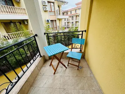 a pair of blue chairs sitting on a balcony at HORIZON 17 'Б' Apartment Sveti Vlas in Sveti Vlas